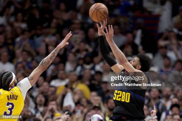 Jamal Murray of the Denver Nuggets puts up a last second shot against Anthony Davis in the fourth quarter to defeat the Los Angeles Lakers during...