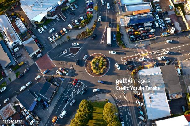a roundabout in a suburb before sunset - urban road stock pictures, royalty-free photos & images