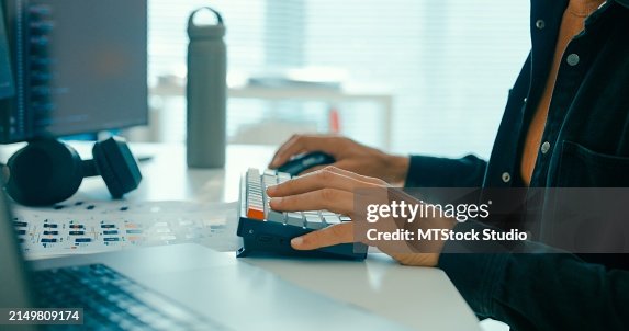 Closeup male programmer writes code for artificial intelligence and data science applications on multiple screens in office. Software developer, artificial intelligence and programming. Closeup male programmer writes code for artificial intelligence and data science applications on multiple screens in office. Software developer, artificial intelligence and programming.