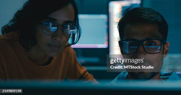 closeup of tech team professionals collaborate discuss software development strategies late night in modern office. software developer, artificial intelligence and programming. - security patch stock pictures, royalty-free photos & images