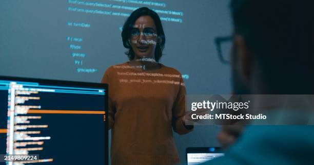 female programmer is giving an interactive training session, focusing on hands-on learning in digital classroom environment. software developer, artificial intelligence and programming. - software programmer stock pictures, royalty-free photos & images