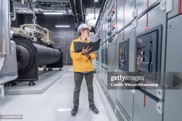 engineer working and check status switchgear electrical energy distribution at substation room - schaltschrank stock-fotos und bilder
