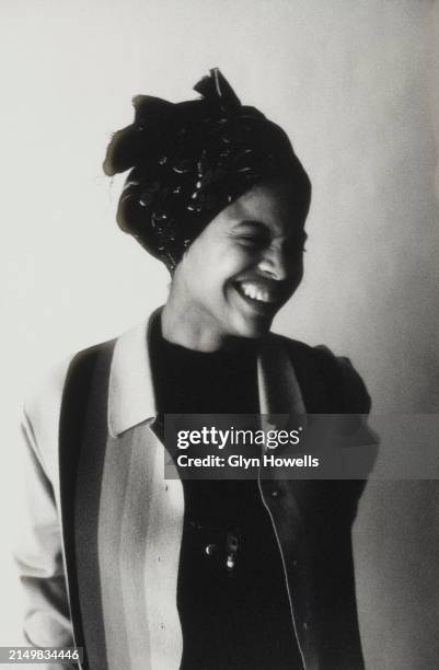 Woman is posed wearing a 'yardie' cardigan and headband, circa 1992.