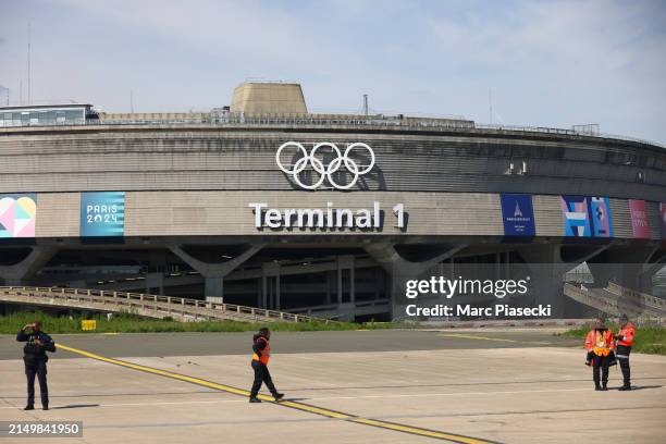 Olympic rings on the Roissy - Charles de Gaulle Airport terminal 1 are unveiled at Airport Roissy Charles de Gaulle on April 23, 2024 in Paris,...