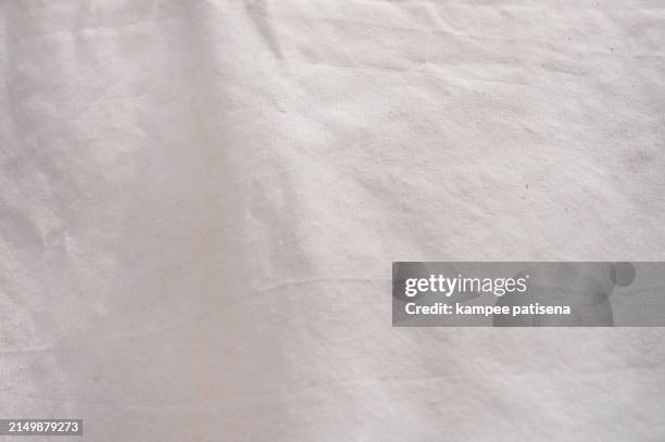a whtie fabric with a pattern of lines and dots. the fabric is soft and smooth to the touch - drap photos et images de collection