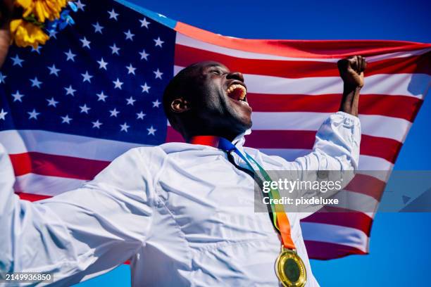 exuberant athlete standing on the podium with an american flag in the background. international sports event concept outdoor portrait. - olympic podium stock pictures, royalty-free photos & images