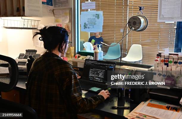 Admin assistant Gelsey Normand takes calls for appointments as a woman wait in the waiting room at Camelback Family Planning, an abortion clinic in...