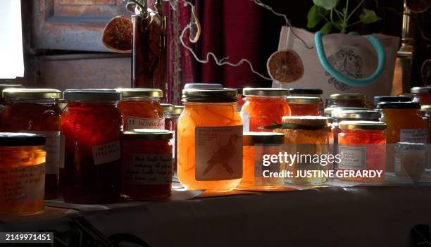 Screenshot taken from an AFP TV video, shows people browsing jars of marmalade entered into the annual Dalemain world marmalade awards, in Penrith,...