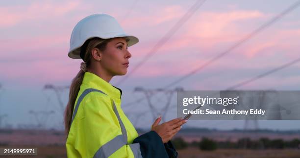 power lines, thinking and woman on tablet for electricity, circuit and voltage infrastructure at night. engineering, maintenance and technician on digital tech for wire, grid and cable inspection - power cable stock pictures, royalty-free photos & images