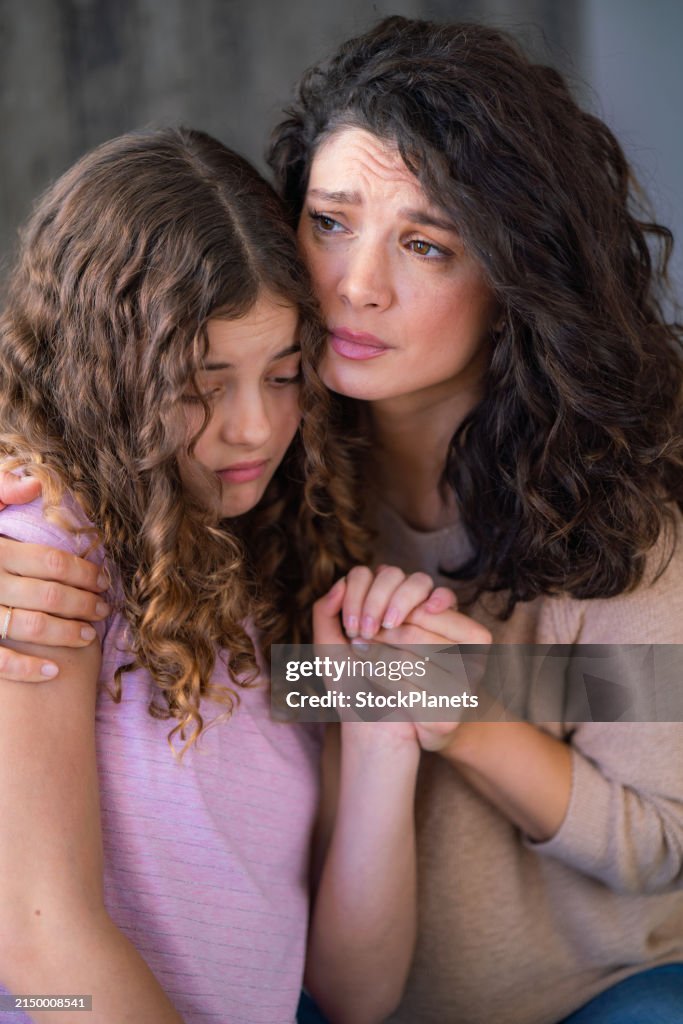 Mother comforting her daughter at home