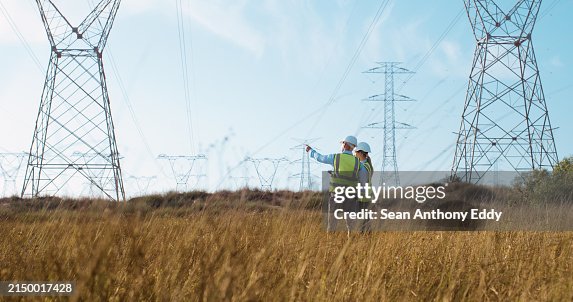 Teamwork, electrical engineer and inspection in power station with people for electricity transmission and tower check. Engineering, back and collaboration for energy distribution or mockup in field Teamwork, electrical engineer and inspection in power station with people for electricity transmission and tower check. Engineering, back and collaboration for energy distribution or mockup in field
