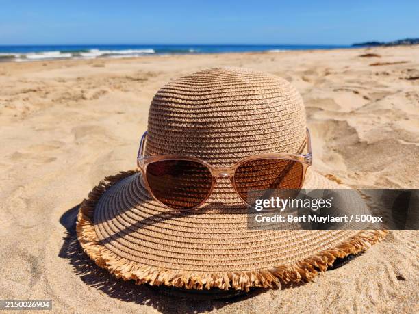 close-up of hat on sand at beach - editorial bildbanksfoton och bilder