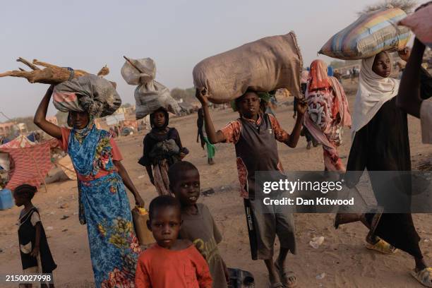 Newly arrived refugees from Darfur in Sudan, head to their shelters on April 24, 2024 in Adre, Chad. Since the beginning of the recent conflict...