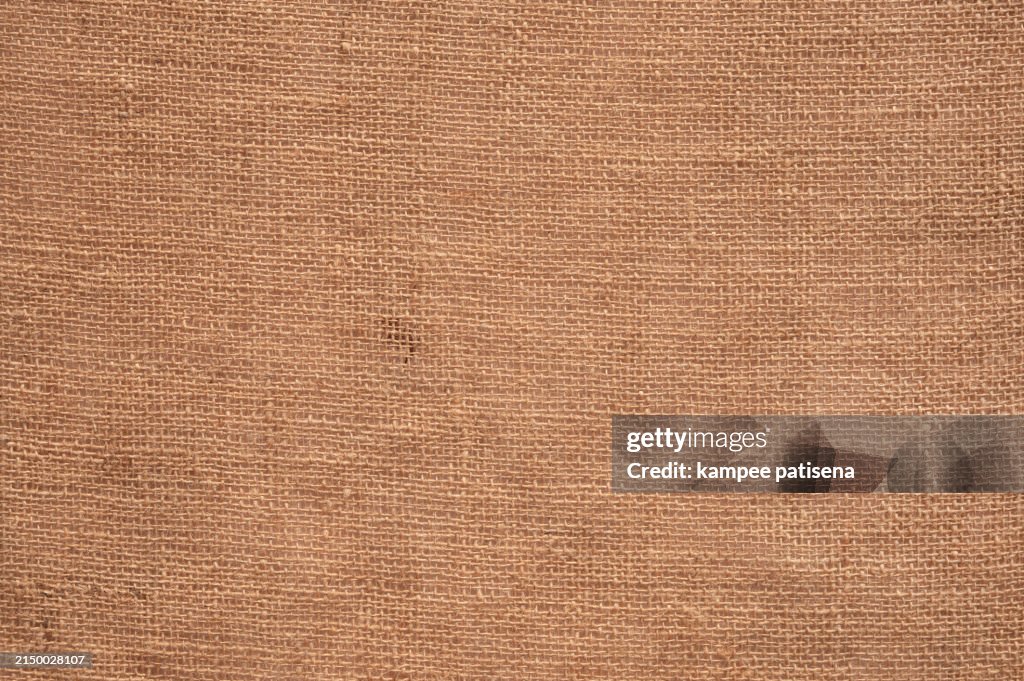 A tan fabric with a pattern of brown. The fabric is soft and has a warm, cozy feeling