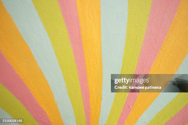 a colorful painting wall of a rainbow with a yellow stripe background - striped wall stock pictures, royalty-free photos & images