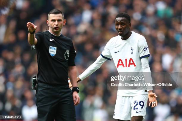 Pape Matar Sarr of Tottenham Hotspur complains to match referee Michael Oliver during the Premier League match between Tottenham Hotspur and Arsenal...