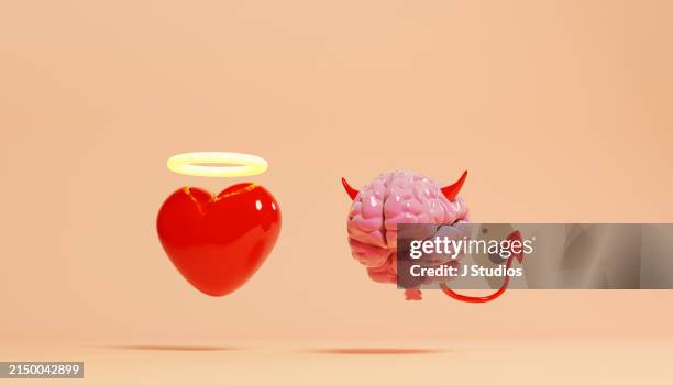 good heart next to evil brain - malvagità foto e immagini stock