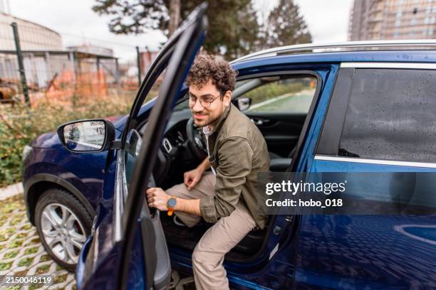 man leaving his car on a parking - car door stock pictures, royalty-free photos & images