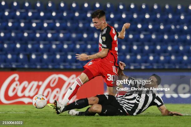 Franco Mastantuono of River Plate and Diego Viera of Libertad battle for the ball during a Copa CONMEBOL Libertadores 2024 Group H match between...