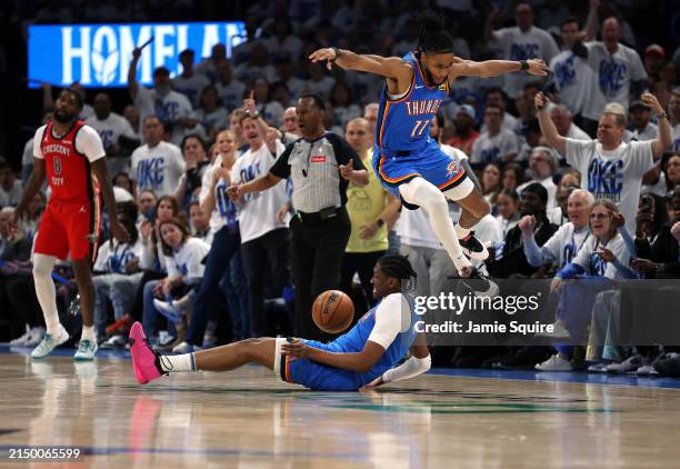 Isaiah Joe of the Oklahoma City Thunder leaps over Jalen Williams while competing for a loose ball during game two of the first round of the NBA...