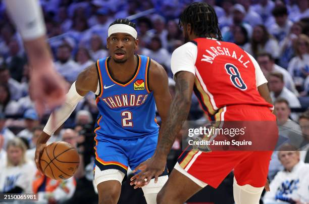 Shai Gilgeous-Alexander of the Oklahoma City Thunder controls the ball as Naji Marshall of the New Orleans Pelicans defends during game two of the...