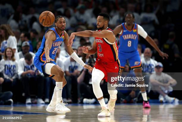 McCollum of the New Orleans Pelicans passes as Cason Wallace and Jalen Williams of the Oklahoma City Thunder defend during game two of the first...