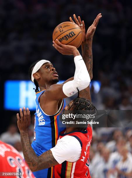 Shai Gilgeous-Alexander of the Oklahoma City Thunder shoots over Naji Marshall of the New Orleans Pelicans during game two of the first round of the...