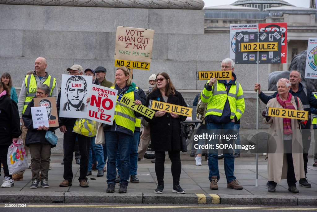 Protesters hold placards during the demonstration on the...