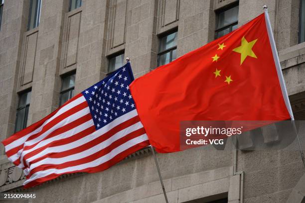 The national flags of the United States and China flutter at the Fairmont Peace Hotel on April 25, 2024 in Shanghai, China. At the invitation of...