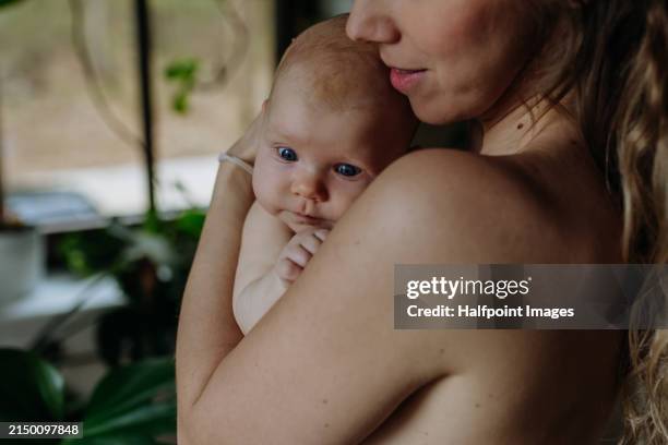 skin to skin, mother with newborn baby. little baby is calm on mother chest. closeness, peaceful moment for new mom. - mole skin stock pictures, royalty-free photos & images