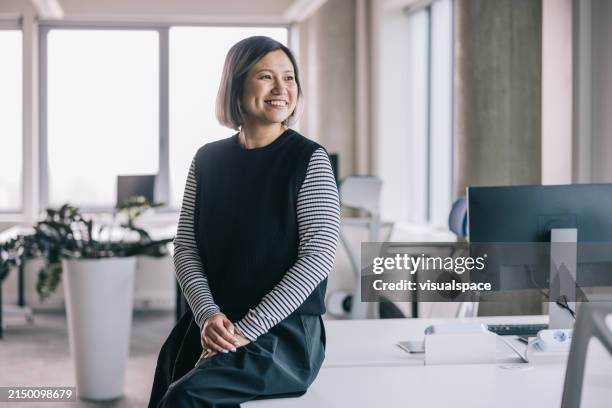 smiling chinese woman at the office - looking away stock pictures, royalty-free photos & images