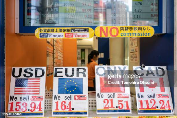 Exchange rates of the yen against the U.S. Dollar, the euro, the Chinese yuan and the Canadian dollar are displayed outside a currency exchange store...