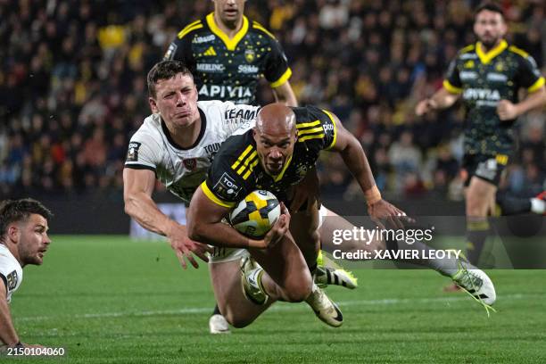 La Rochelle's wing Teddy Thomas is tackled during the French Top14 rugby union match between Stade Rochelais and Rugby Club Toulonnais at the...