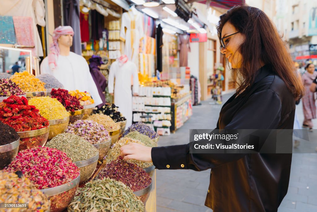 Woman Shopping at Spice and Dyes Market in Dubai City