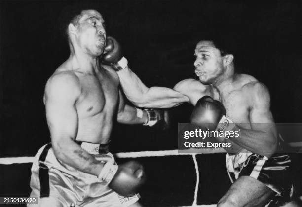British boxer Randolph Turpin is hit by Trinidadian boxer Yolande Pompey during their British Light Heavyweight title fight, at the Perry Barr...