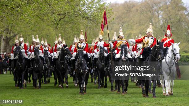 The trooper on the white horse carries a bugle which signals commands during the Major General's annual inspection of the Household Cavalry Mounted...