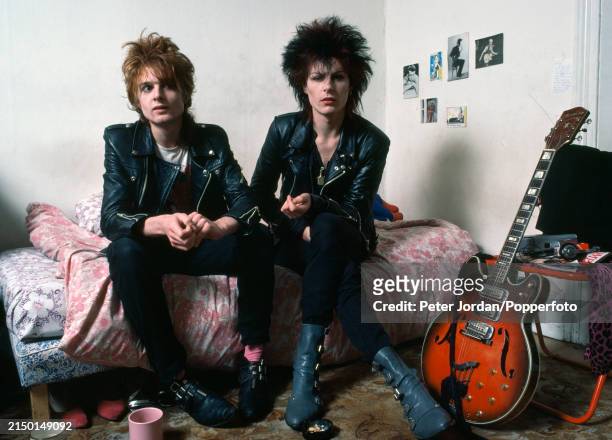 Punks wearing studded leather biker jackets in a bed-sit in London, circa 1983.