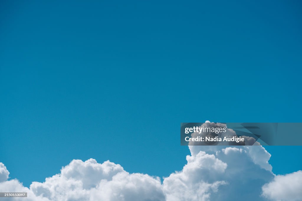 Blue sky and white cumulus clouds on a beautiful dramatic cloud natural background