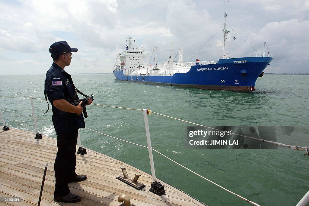 An armed marine policeman stands guard o