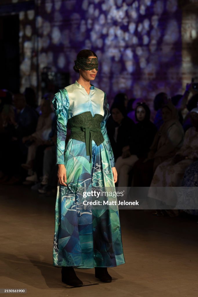 A model is seen on the runway in a design by Sheena Hussain during ...