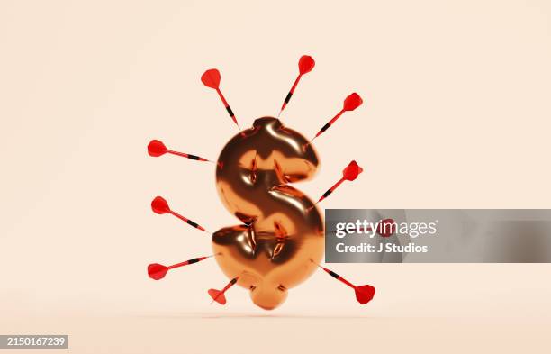 dollar sign balloon surrounded by darts - balloon darts stock pictures, royalty-free photos & images