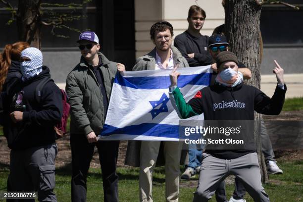 People hold up an Israeli flag as students gather to show support for the people of Gaza on the campus of Northwestern University on April 25, 2024...