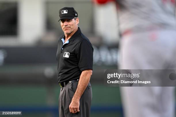 Second base umpire Angel Hernandez looks on during the fourth inning of a spring training game between the St. Louis Cardinals and the Washington...