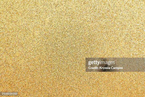 golden colored glittering background - lentejuela fotografías e imágenes de stock