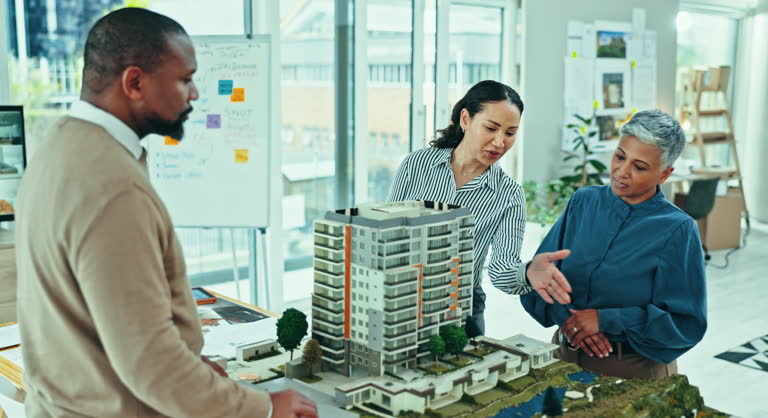 https://media.gettyimages.com/id/2150234905/video/business-people-model-and-architecture-design-in-office-for-city-planning-development-or.jpg?b=1&s=640x640&k=20&c=1Rii7l1VoLOc6iBbamlVKFFRPyYf5SmiuFSkcqkozfY=