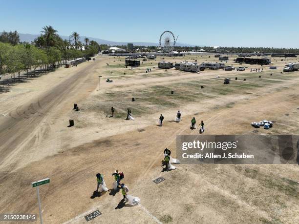 Crews pick up trash and items that got left behind after the Stagecoach Festival, which concluded Sunday at the Empire Polo Fields in Indio Monday,...