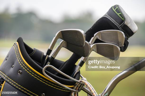 close up of golf clubs in a golf bag. - golf bag stock pictures, royalty-free photos & images
