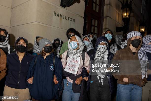 Students/demonstrators lock arms to guard potential authorities against reaching fellow protestors who barricaded themselves inside Hamilton Hall, an...