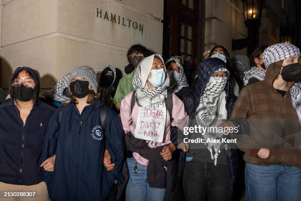 Students/demonstrators lock arms to guard potential authorities against reaching fellow protestors who barricaded themselves inside Hamilton Hall, an...