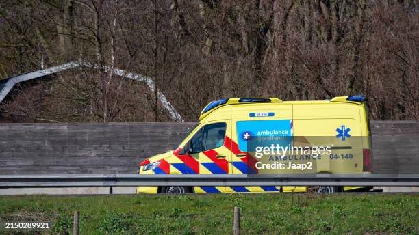 dutch mercedes ambulance driving on the n36 - ambulance nederland stockfoto's en -beelden
